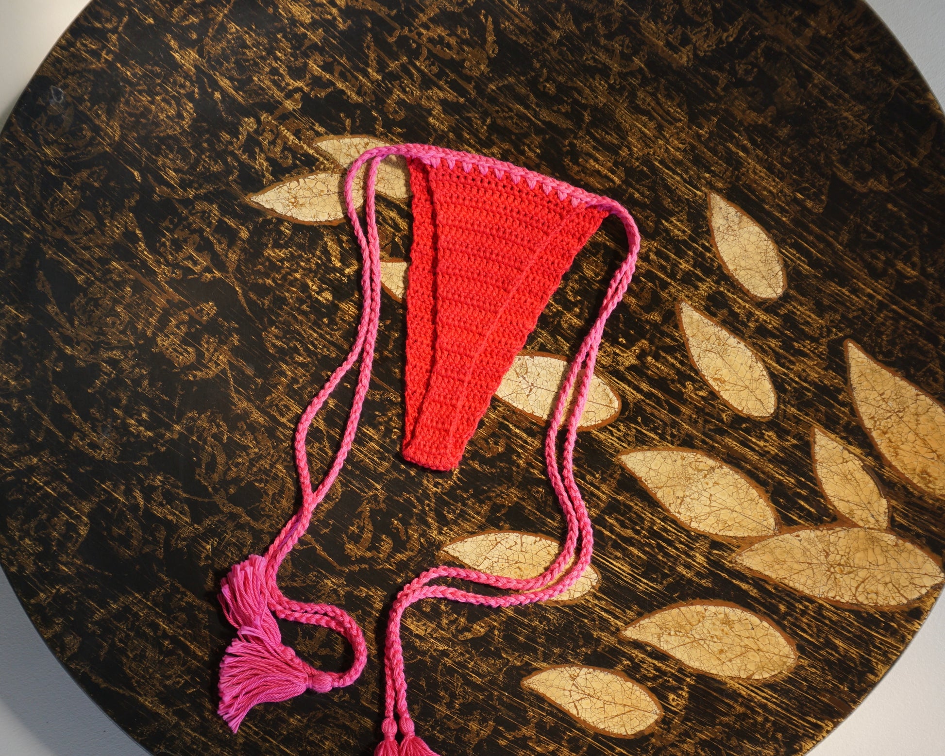 red and pink brazilian crochet bikini set with tassels for swimming flatlay back